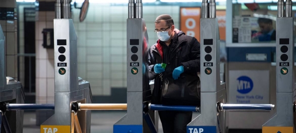 A man wears a mask and gloves as he enters the subway system during the Coronavirus (COVID-19) outbreak in New York City. — Courtesy photo
