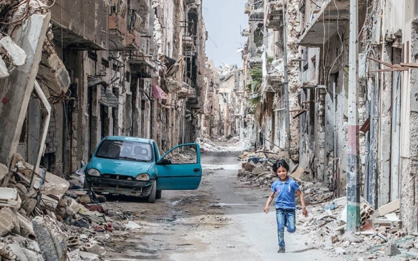 A child runs through the debris and wreckage in downtown Benghazi, Libya. — courtesy UNICEF/Giovanni Diffidenti