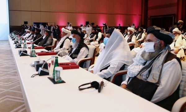US Secretary of State Mike Pompeo speaks as Zalmay Khalilzad, US envoy for peace in Afghanistan, are seen during talks between the Afghan government and Taliban insurgents in Doha, Saturday.