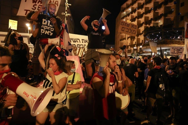 Israeli protesters shout slogans during an anti-government demonstration in front of Prime Minister Benjamin Netanyahu's residence in occupied Jerusalem, Saturday evening. — Courtesy photo