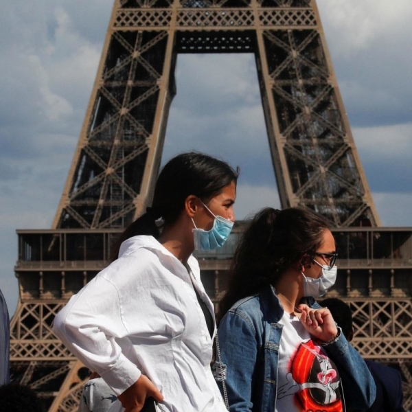 French females wear face masks near Eiffel Tower. — File photo
