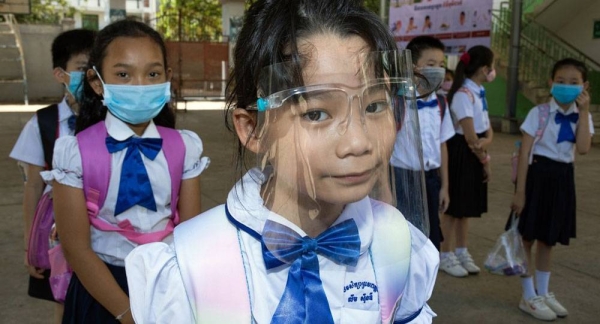Students at a primary school in Phnom Penh, Cambodia, on the second day after their school reopened. The students, teachers and school administrators wear masks while at the school and maintain physical distancing. — courtesy UNICEF/Seyha Lychheang
