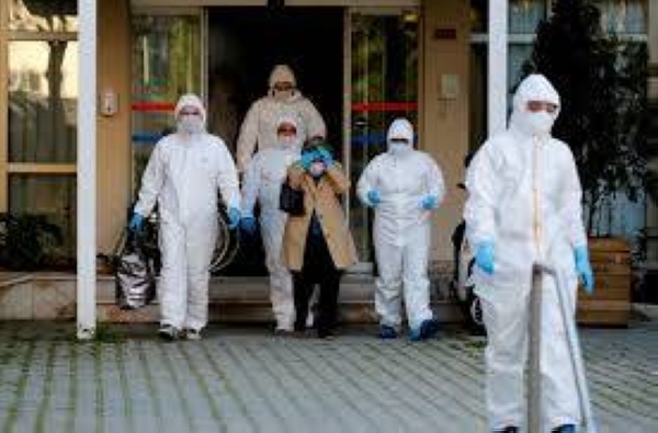 Paramedics escort a woman as she walks toward an ambulance in Istanbul in this file photo.
