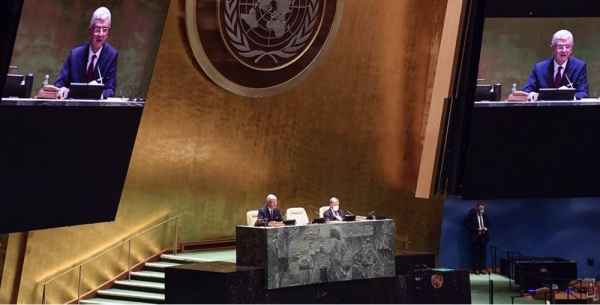 Volkan Bozkir (left at dais and on screens), President of the 75th session of the United Nations General Assembly, chairs the first plenary meeting of the 75th session of the General Assembly. — courtesy UN Photo/Evan Schneider