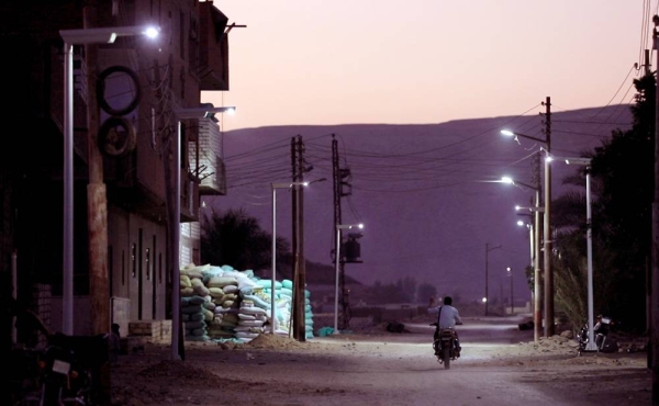 Staff installing the solar lights in Habisha Village, Asyut