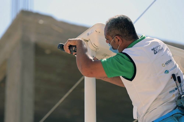 Staff installing the solar lights in Habisha Village, Asyut