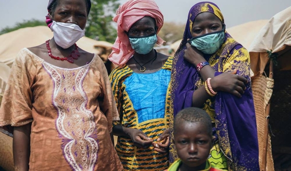 In Niger attacks by armed groups have been on the rise, exacerbating the plight of communities reeling under the impact of the pandemic. Pictured here, a woman with members of her family, who were forced to flee their homes due to violence and insecurity. — courtesy UNICEF/Juan Haro