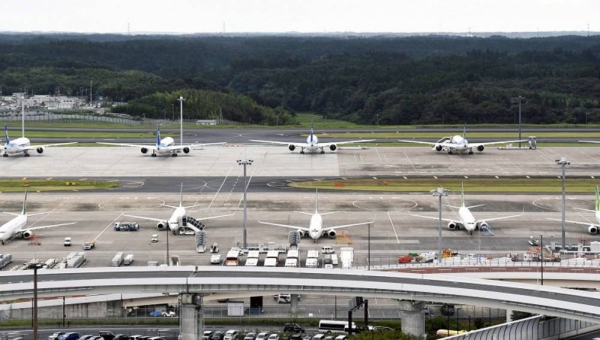 File photo taken on Sept. 11, 2020, shows passenger planes parked on a taxiway at Narita airport near Tokyo. (Kyodo)