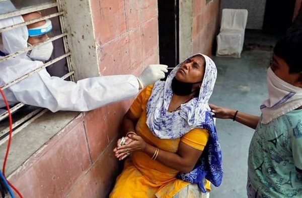 A lady undergoes the swab test for coronavirus in an Indian village.