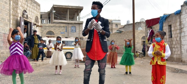 A volunteer guides and instructs girls in a town in Yemen, on the proper way to wash their hands. — Courtesy photo