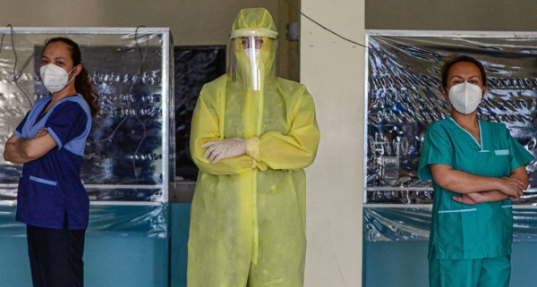 
Wearing a full protective suit, a women doctor who leads a group of volunteer medical professionals attending to COVID-19 patients and persons under investigation at a community hospital in the Philippines. — courtesy UN Women/Louie Pacardo