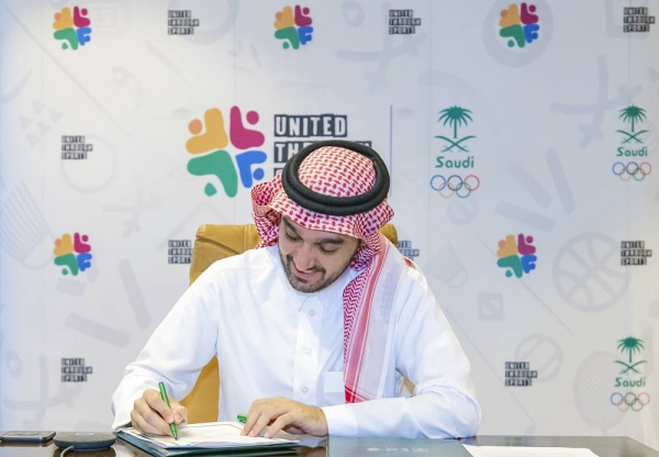 President of the Saudi Arabian Olympic Committee (SAOC) Prince Abdulaziz Bin Turki Al-Faisal signing the MoU.