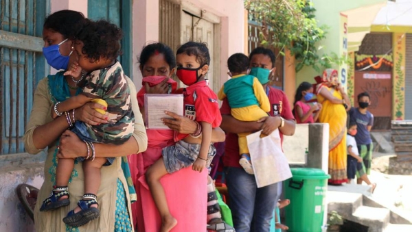 Parents and caregivers line up with their children at an immunization center in Janakpur, southern Nepal. — courtesy UNICEF