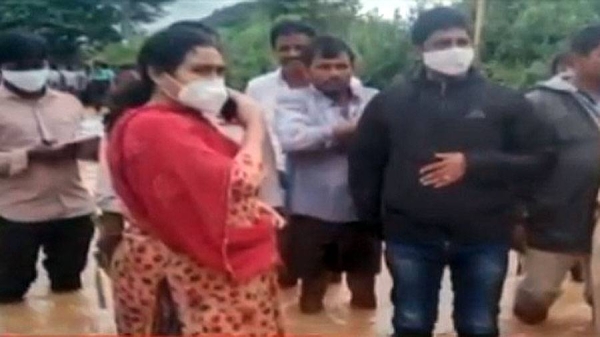 Govt officials, standing in knee-deep water, assessing the situation in an area in Telangana.