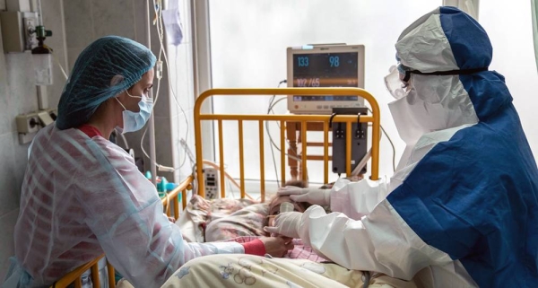A mother and doctor tend to a young girl with COVID-19 at an intensive care ward in the western region of Chernivtsi, Ukraine. — courtesy UNICEF/Evgeniy Maloletka