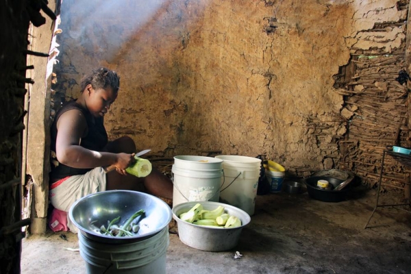 Osena Previlon’s older daughter 14-year-old Bevalie Jean-Jacques, peels eggplants brought by her mother from the field as she helps with preparing lunch in the family’s kitchen – a little mud house separated from the main house. — courtesy WFP/Alexis Masciarelli