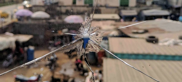 A view of a street in Lagos, Nigeria, through a shattered glass window. — Courtesy photo