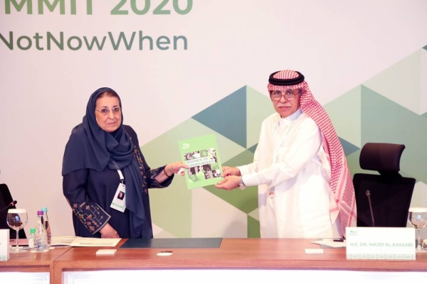 Dr. Majid Al Qasabi, minister of commerce, chair of G20 Trade and Investment, representing the Presidency of the G20 receives the W20 Communiqué from Dr. Thoraya Obaid, W20 Chair.