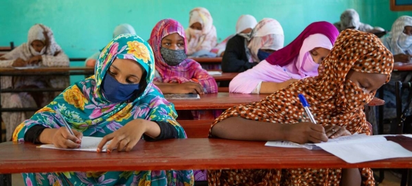 Teachers and students wear face masks and maintain physical distance at a school in Cambodia. — Courtesy photo