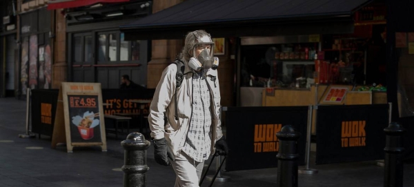 A masked man walking in London's West End in this file photo. — Courtesy photo