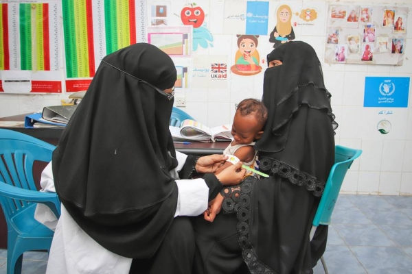 Malnutrition surges among young children in Yemen as conditions worsen. WFP provides nutrition support to children and mothers in Yemen to both treat and prevent malnutrition. — courtesy Alaa-Noman

In the photo: The midwife is conducting the necessary checks such as temperature measurement and MUAC measurement.

Left to right: 
Ashjan, (midwife), Rafiq, (7 months child) and Intisar, (mother 32) 

Photo: © WFP/Alaa Noman