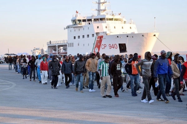 Shipwrecked migrants disembark from a rescue vessel as they arrive in the Italian port of Augusta in Sicily in this April 16, 2015 file photo. — AFP