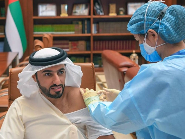 A health worker injects the COVID-19 vaccine to Sheikh Rashid Bin Humaid Al Nuaimi, president of the UAE Football Association (UAEFA).