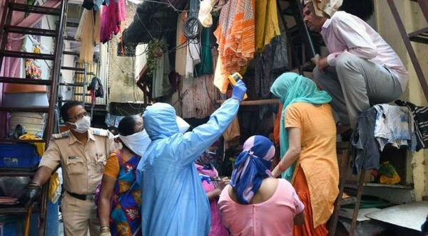 File photo shows, health workers, escorted by Mumbai police, test people fore COVID-19 in Dharavi, the city's biggest slum.