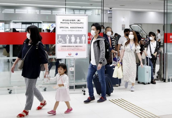An arrival lobby at Tokyo's Haneda airport is crowded with people on Oct. 4, 2020, the first weekend after the Japanese capital was added to the 