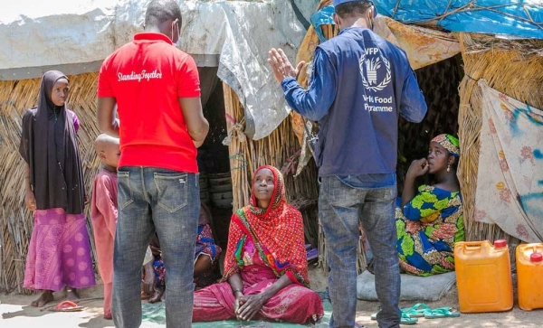 COVID-19 is undermining nutrition among the world’s most vulnerable people, particularly children, pregnant and breastfeeding mothers. Pictured here, a WFP staff member interviews displaced persons at an informal IDP settlement in Maiduguri, Nigeria. ‘ — courtesy WFP/Oluwaseun Oluwamuyiwa