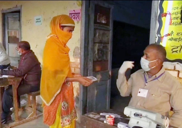 A women in Bihar shows her ID to the security at a polling booth prior to casting her vote in the Bihar Assembly elections. The NDA emerged triumphant.