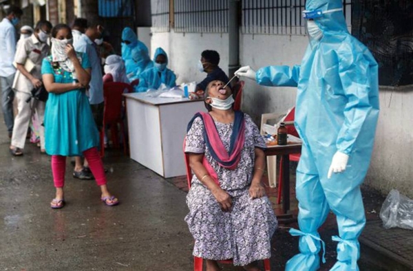 Health workers test Indian waiting in line for coronavirus. India has the second-highest number of infections in the world, after the United States, but the rate of increase in India has dipped since it hit a peak in September.