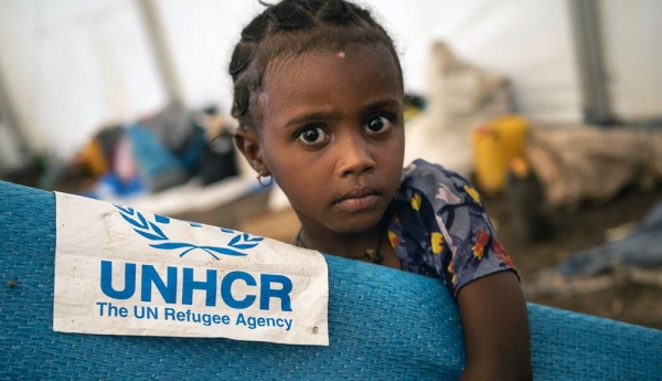 A young Ethiopian refugee collects a mattress at a transit site in Hamdayet, Sudan. According to UNHCR, the number of refugees streaming into eastern Sudan has surpassed 40,000 since the crisis began. — courtesy UNHCR/Olivier Jobard