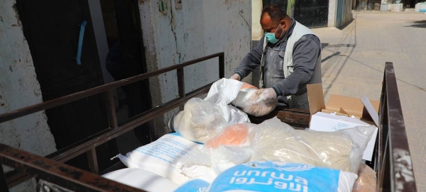 Families in Gaza receive food baskets through the UNRWA home delivery program in this file picture. — Courtesy photo