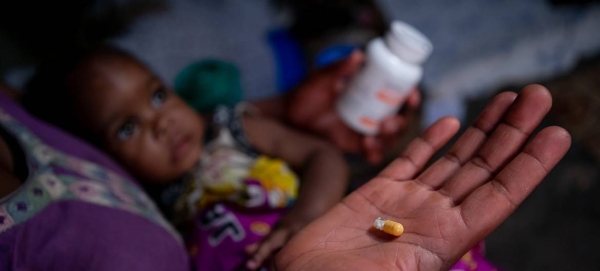 A mother in Mbarara, Western Uganda, ensures that both her children receive their pediatric HIV medicine at the same time every day. — Courtesy photo