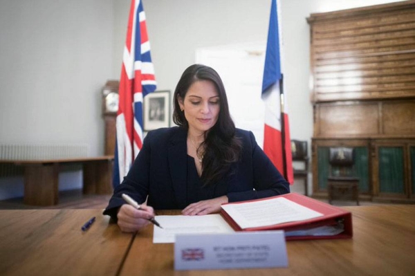  British Home Secretary Priti Patel seen signing an agreement on Saturday to beef up police presence in the English Channel with her French counterpart Gerald Darmanin.
