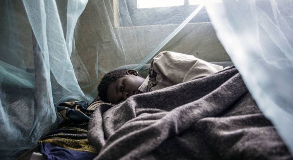 A child sleeps under an insecticide treated mosquito net for protection against malaria. — courtesy UNICEF/Colfs
