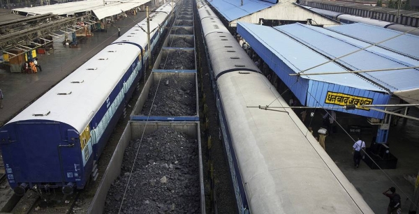 A new report has urged countries to cut the production of fossil fuels by 6 percent, per year, to avoid catastrophic global warming. Pictured here, a cargo train, laden with coal, waits at a railway station in India. File photo courtesy ESCAP Photo/Christian Dohrmann