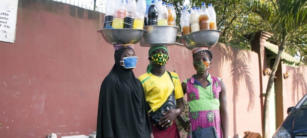 Three young women wearing masks are selling medicine on the street during the COVID-19 crisis in Abidjan, Côte d'Ivoire. — Courtesy photo
