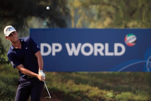 Andy Sullivan of England interacts with his caddie Thomas Riley  on the 18th hole during Day Three of the Golf in Dubai Championship at Jumeirah Golf Estates on Friday in Dubai, United Arab Emirates. (Photo by Andrew Redington/Getty Images)