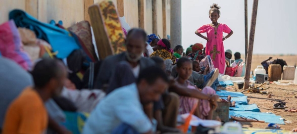 Refugees from Ethiopia sit in the shade to avoid the hot afternoon sun at the Hamdayet Border Reception Centre in eastern Sudan. — Courtesy photo