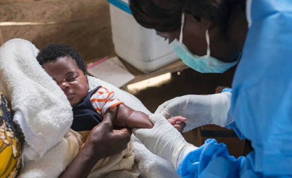 A nurse prepares to vaccinate an infant during a regularly-scheduled immunization clinic in North Kivu province, Democratic Republic of the Congo. — courtesy UNICEF/Thomas Nybo
