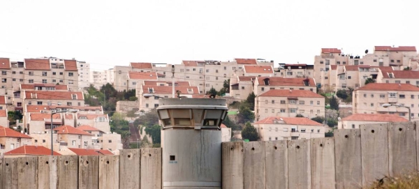 The Separation Wall in the occupied Palestinian Territory and behind it Israeli settlements are seen. — Courtesy photo
