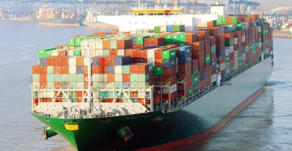 A container ship unloads its cargo at a port. — courtesy IMO