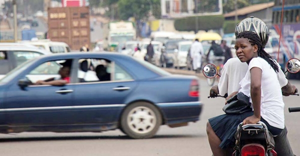 

A Boda Boda rider and passenger wait at a junction in Kampala, Uganda. — courtesy World Bank/Sarah Farhat