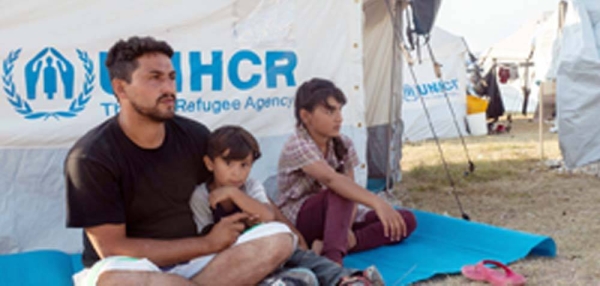 A 33-year-old man from Afghanistan, pictured with his family on the Greek island of Lesvos, is hoping to be relocated to Germany. — courtesy UNICEF/Canaj Magnum Photos