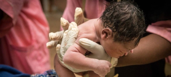 Midwife lifts one of the very first babies born in Mali in 2020 at a Health Center in Segou, central Mali, in this courtesy file picture. 