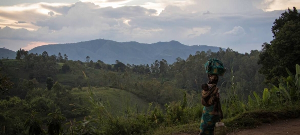 A woman, carrying her child, walks back to her home from the fields in D.R. Congo’s North Kivu province. in this courtesy file photo.