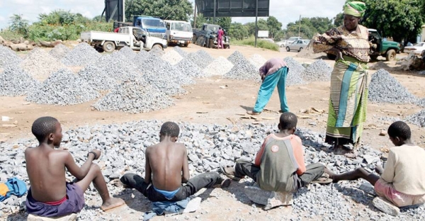 File photo shows a woman watching children working at a stone quarry, Zambia. — courtesy IRIN/M. Deghati