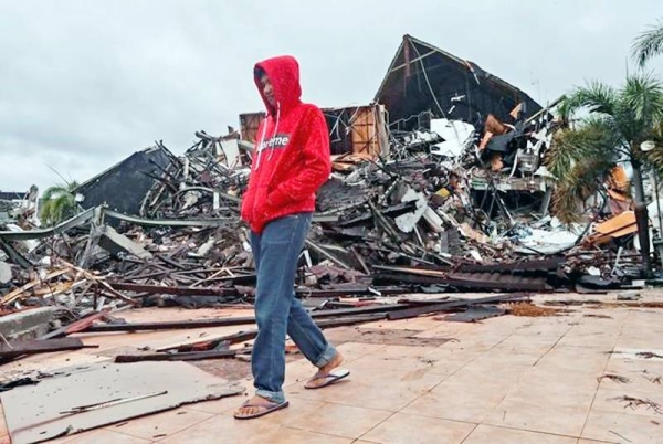 ndonesian rescuers retrieved more bodies from the rubble of homes and buildings toppled by a 6.2 magnitude earthquake, raising the death toll to 56 on Sunday, while military engineers managed to reopen ruptured roads to clear access for relief goods.